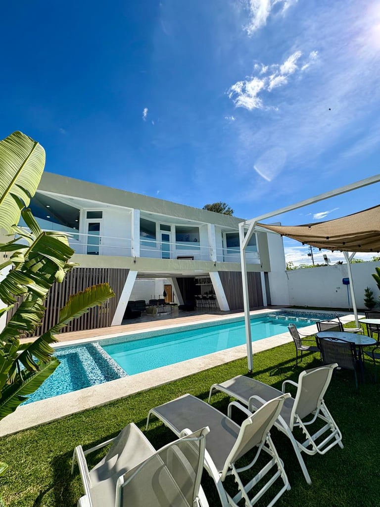 Modern white two-story house with swimming pool