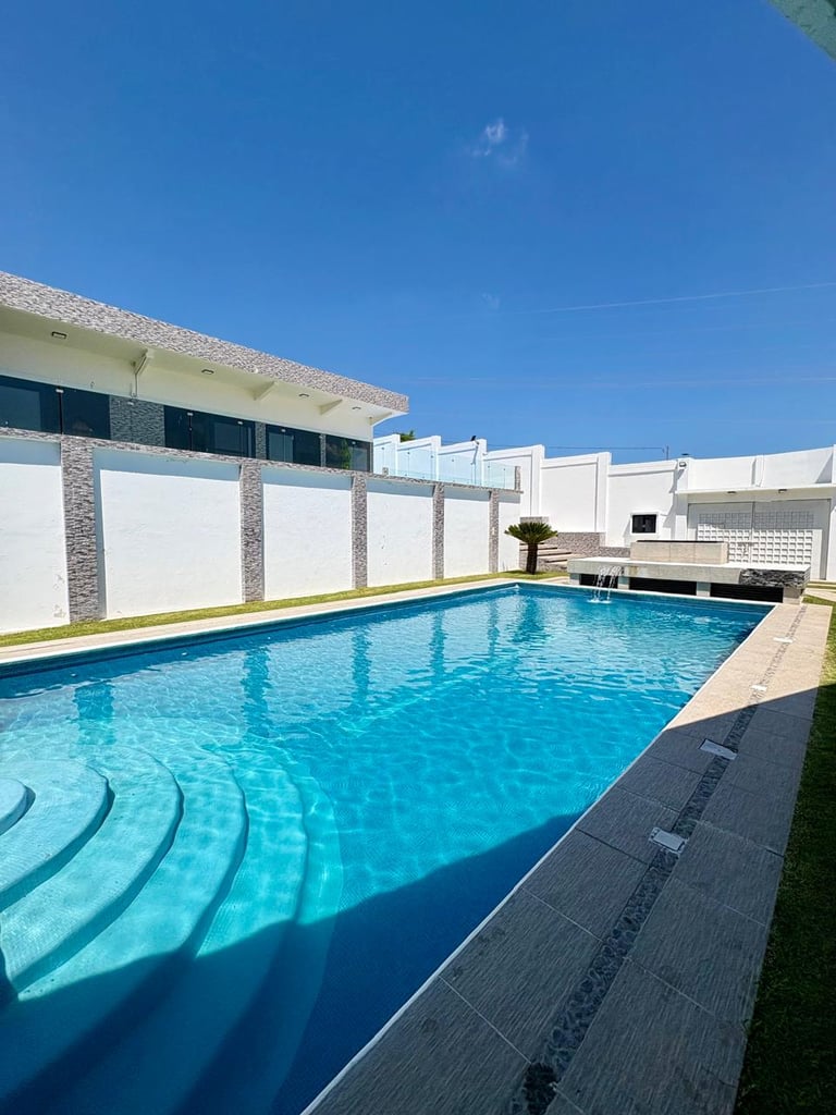 Modern backyard swimming pool with crystal clear blue water