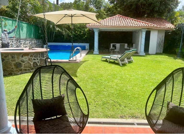 Backyard patio with pool and lounge chairs